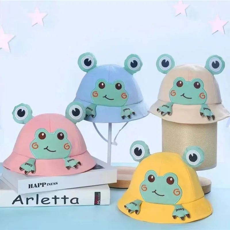 Infant baby frog bucket hat, soft fabric, designed for sun safety. Cute children's accessory.