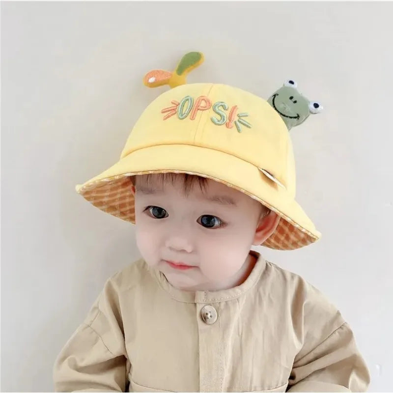 Close-up of a baby frog bucket hat, highlighting cute frog eyes and texture. Perfect for sun protection.
