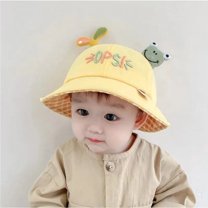 Close-up of a baby frog bucket hat, highlighting cute frog eyes and texture. Perfect for sun protection.
