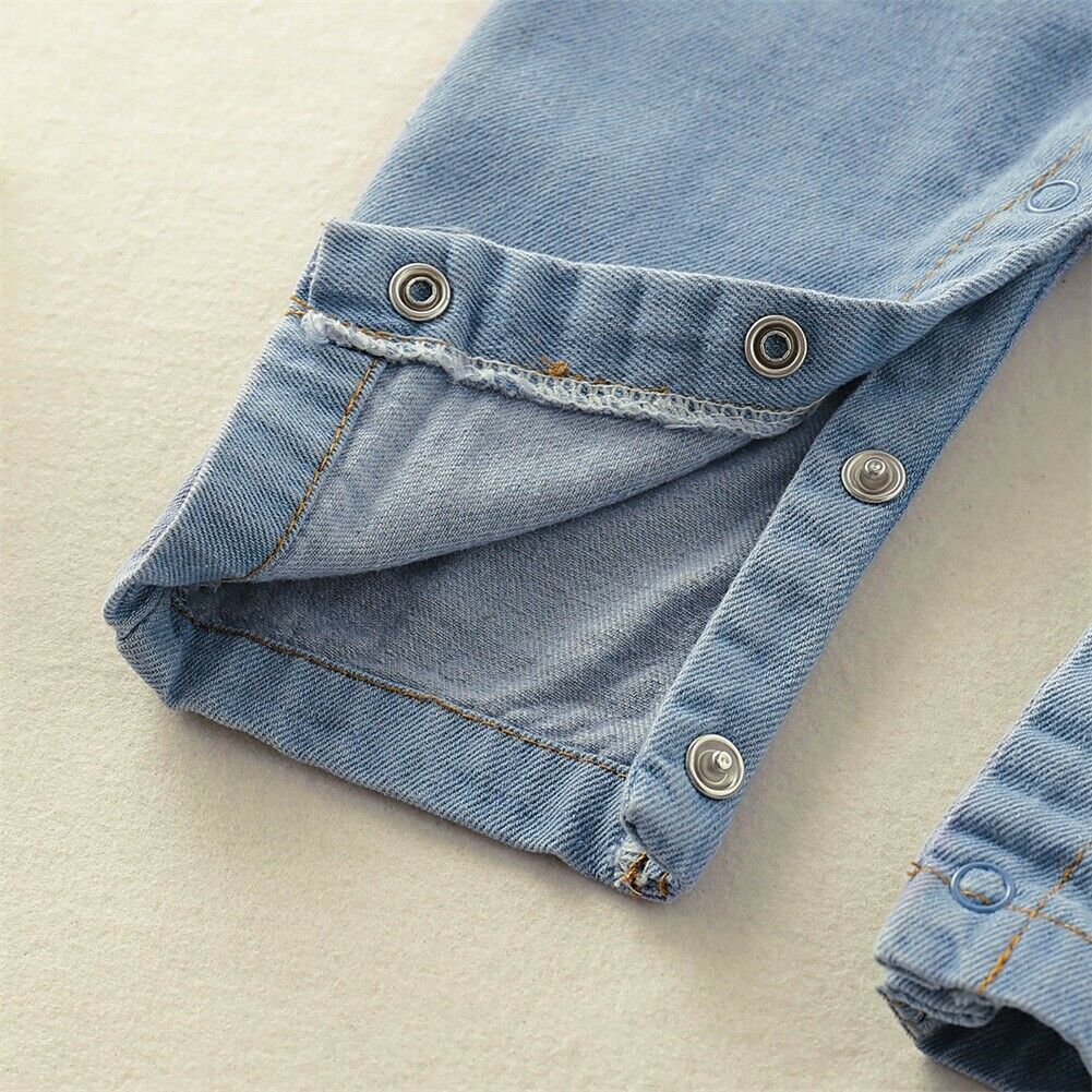 Toddler girl wearing a comfortable and cute denim ruffle romper for summer playtime.
