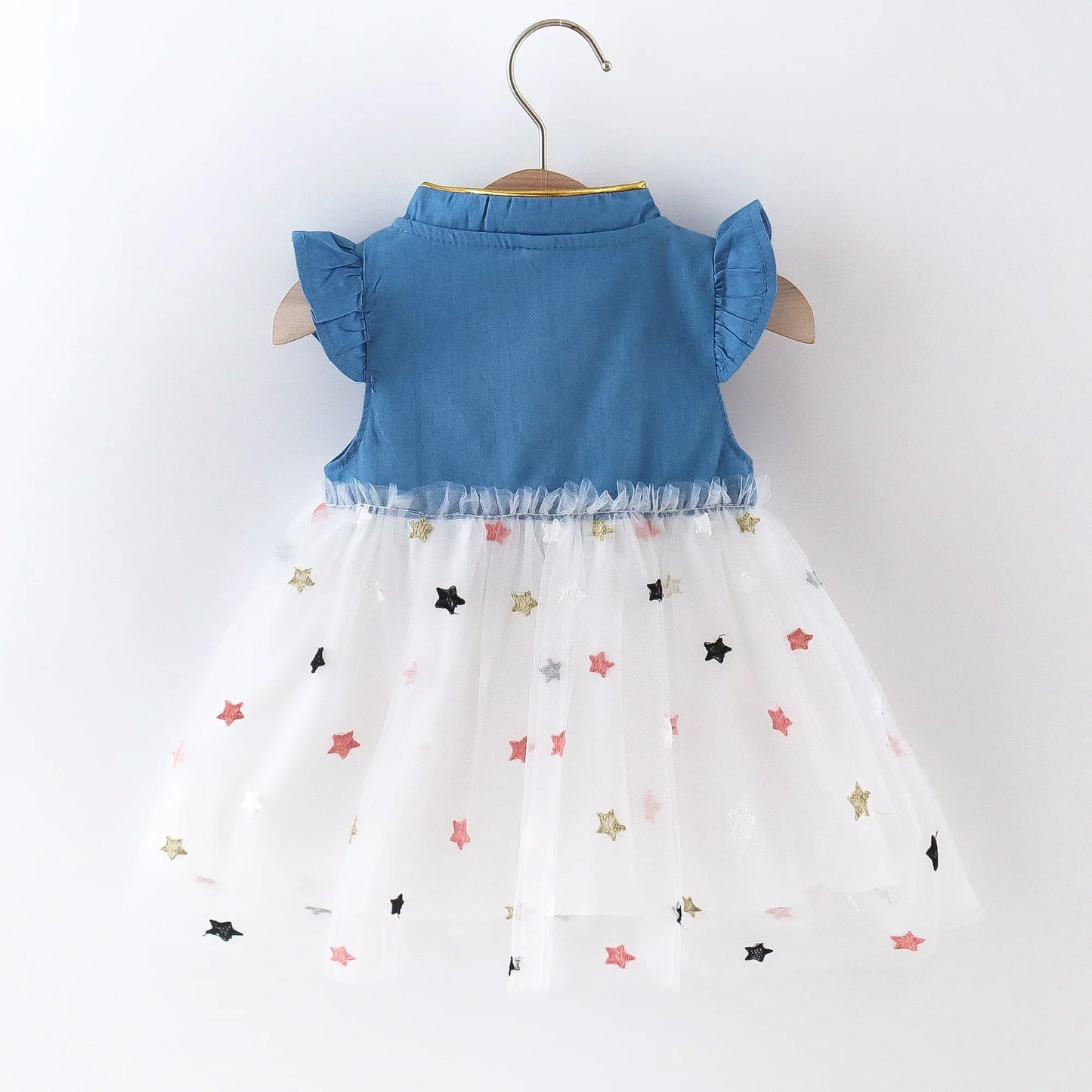 Close-up of the denim bow detail on a cute girls' dress with delicate flying sleeves.