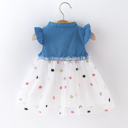 Close-up of the denim bow detail on a cute girls' dress with delicate flying sleeves.