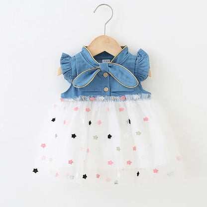 Pretty girls' denim summer dress with a charming bow and unique flying sleeve design.