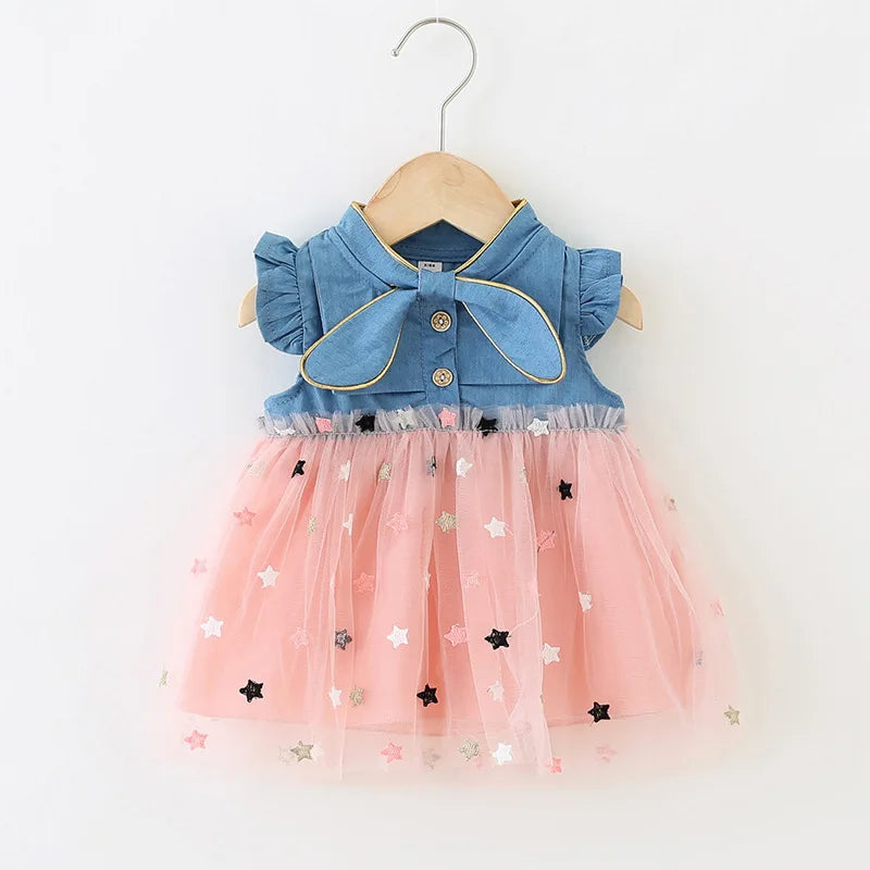 Children's wear: A lovely denim dress for girls, showcasing bow accent and playful flying sleeves.