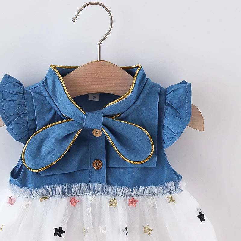 Fashionable baby girl denim dress, ideal for warm weather, with a sweet bow and flying sleeves.
