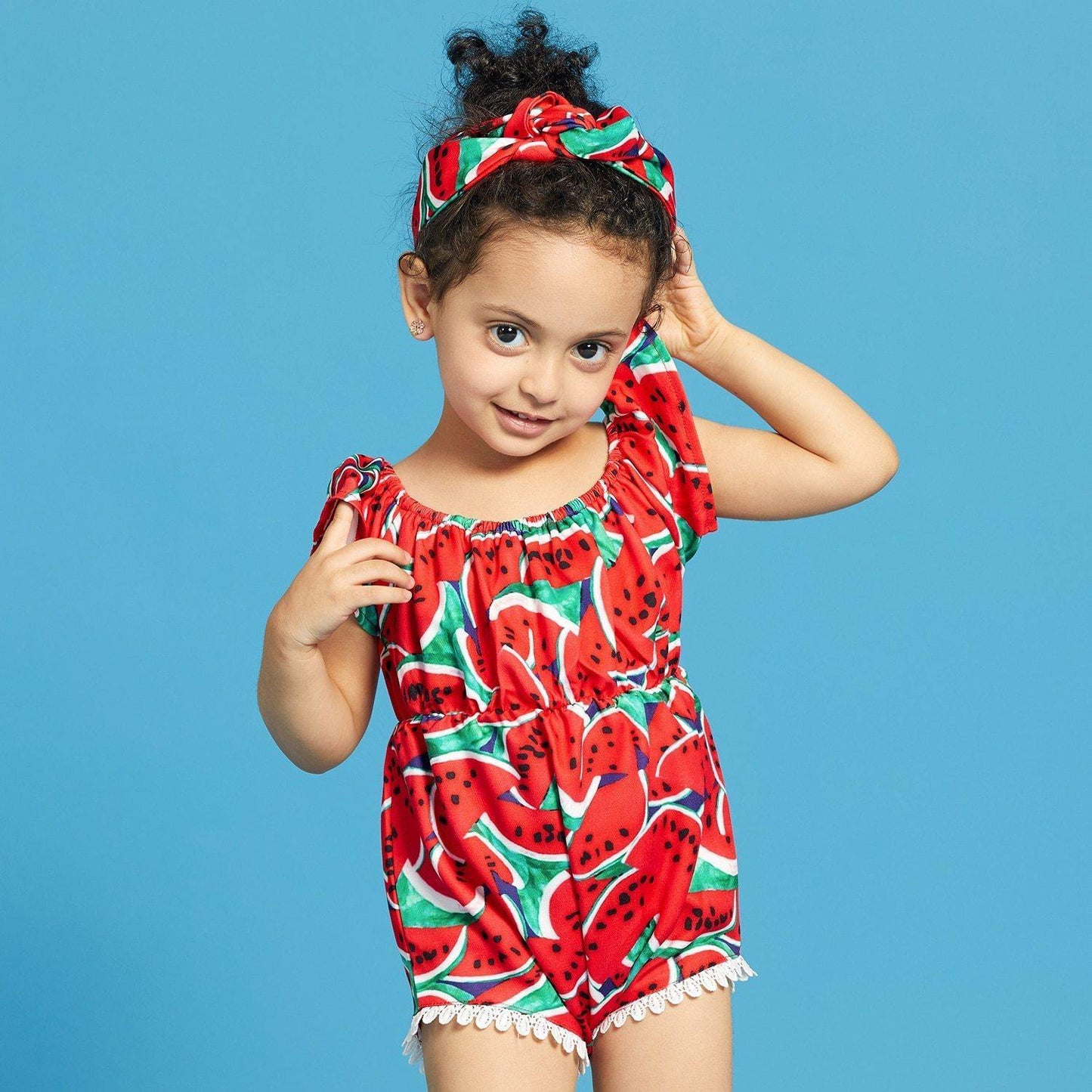Adorable baby girl in a watermelon print swimsuit with a matching headband, perfect for summer beach wear