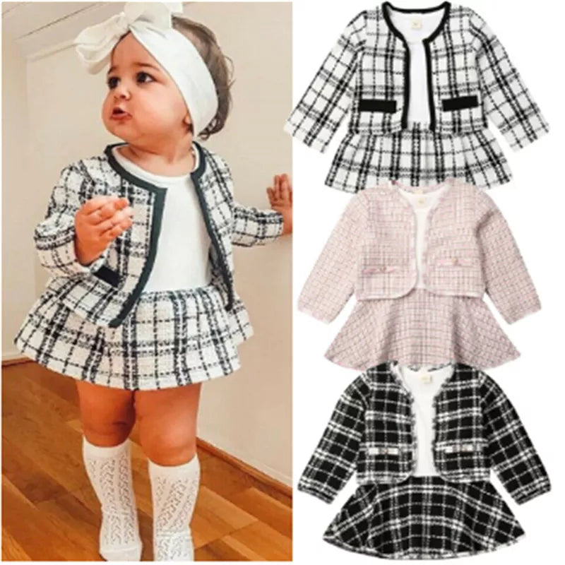 Adorable baby girl in red plaid coat and black tutu dress, perfect for a party outfit