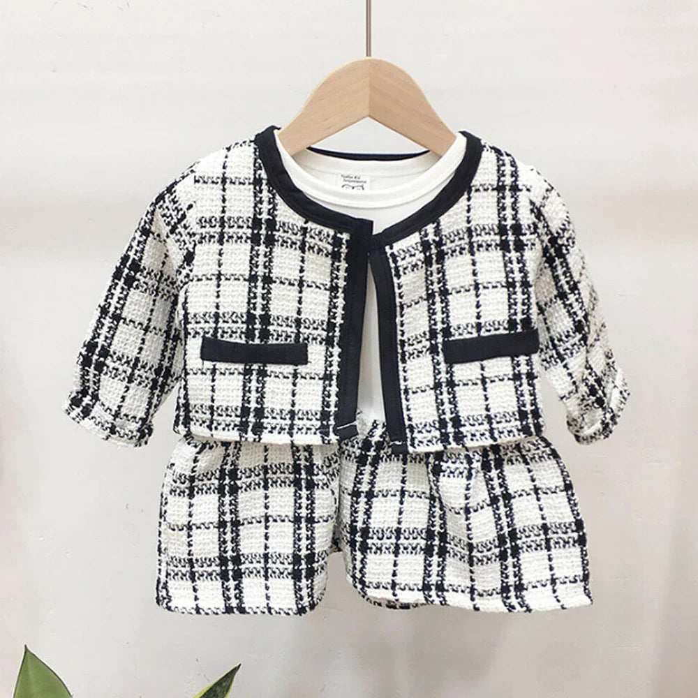 Cute baby outfit: vibrant red plaid coat and voluminous black tutu dress, comfortable fit