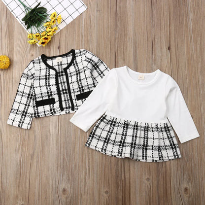 Fashionable toddler girl in a classic red plaid coat, showcasing front button detail