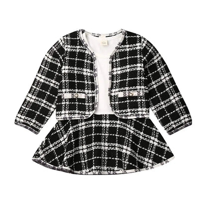 Baby girl autumn outfit: warm red plaid coat over a stylish black tutu formal dress