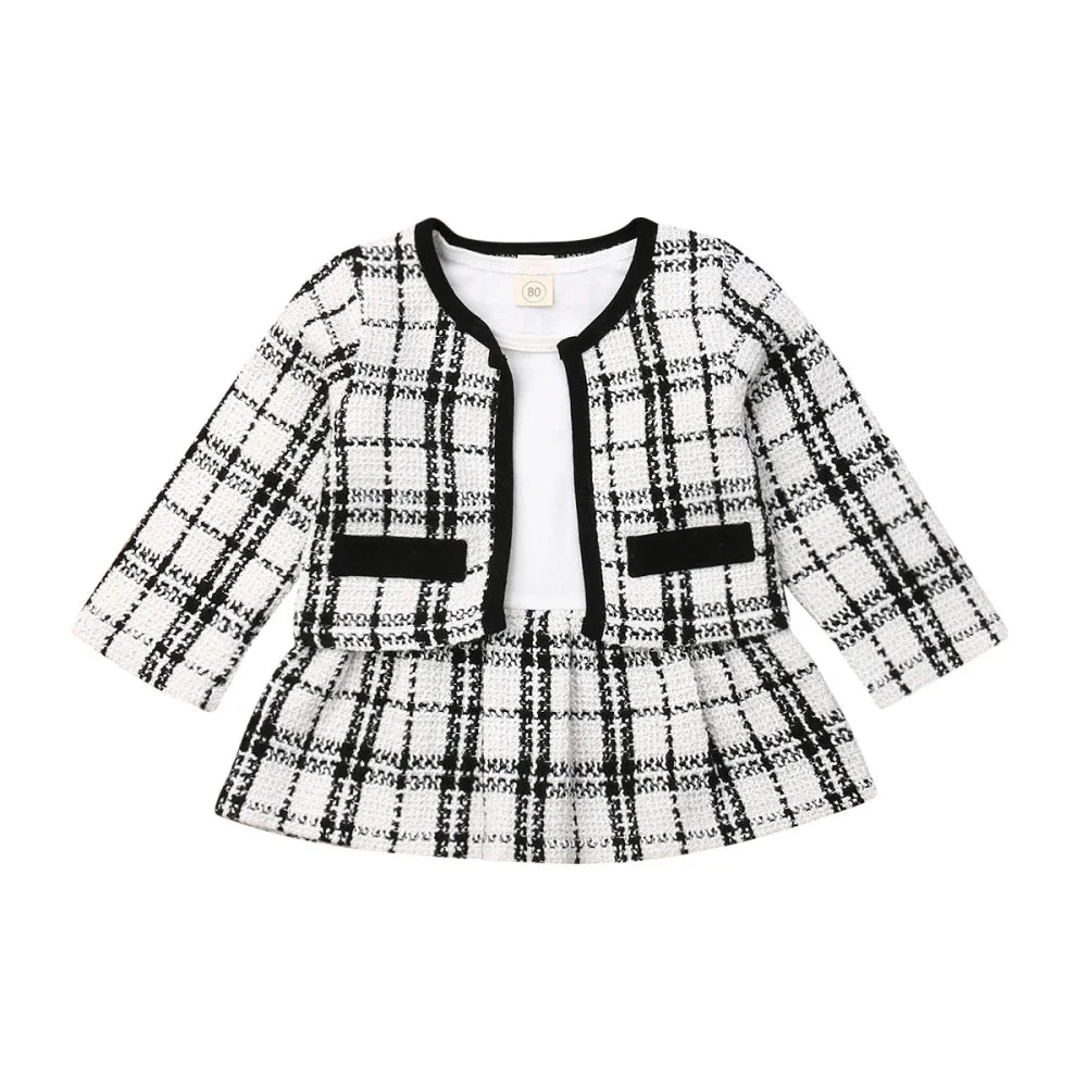 Detail of the red and black plaid pattern on a baby girl's coat, quality kids clothing