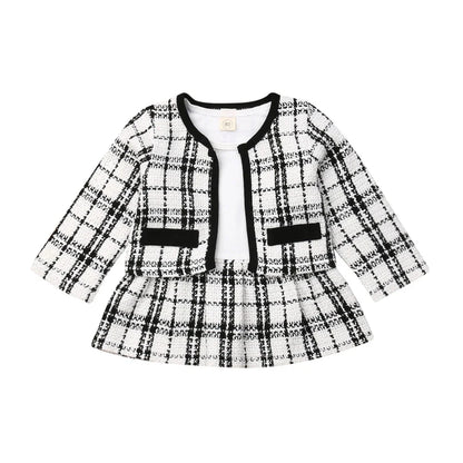 Detail of the red and black plaid pattern on a baby girl's coat, quality kids clothing