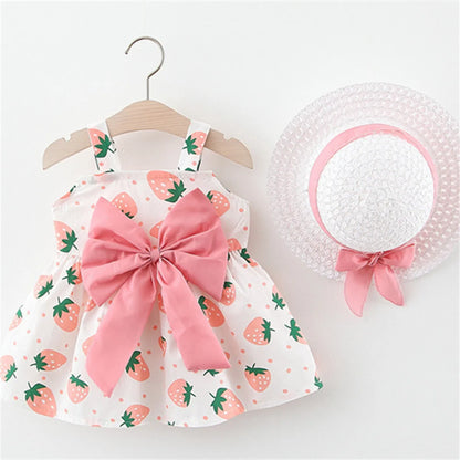 Stylish baby girl's summer dress and sun hat set, featuring a charming red strawberry print.