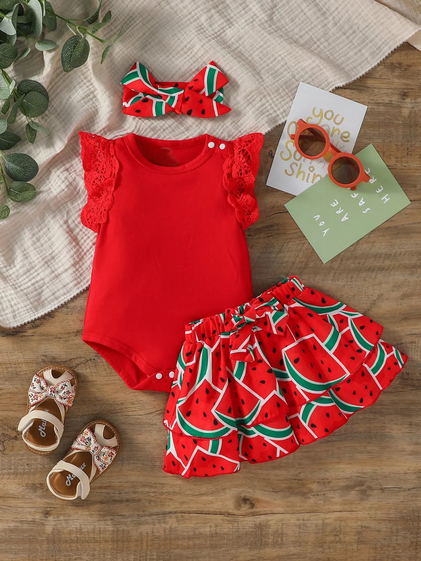 Adorable baby girl in watermelon print romper, skirt, and headband set, perfect for summer playwear