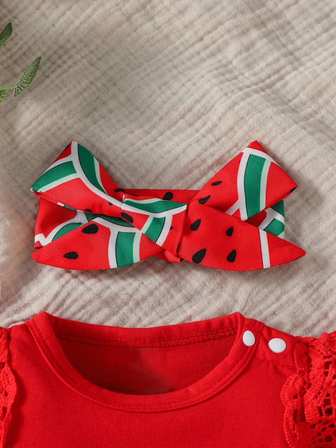 Toddler girl's summer outfit featuring a frilly watermelon skirt and matching headband