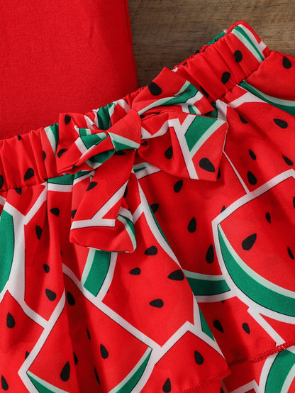 Detail of the soft fabric and vibrant watermelon print on a baby girl's summer outfit