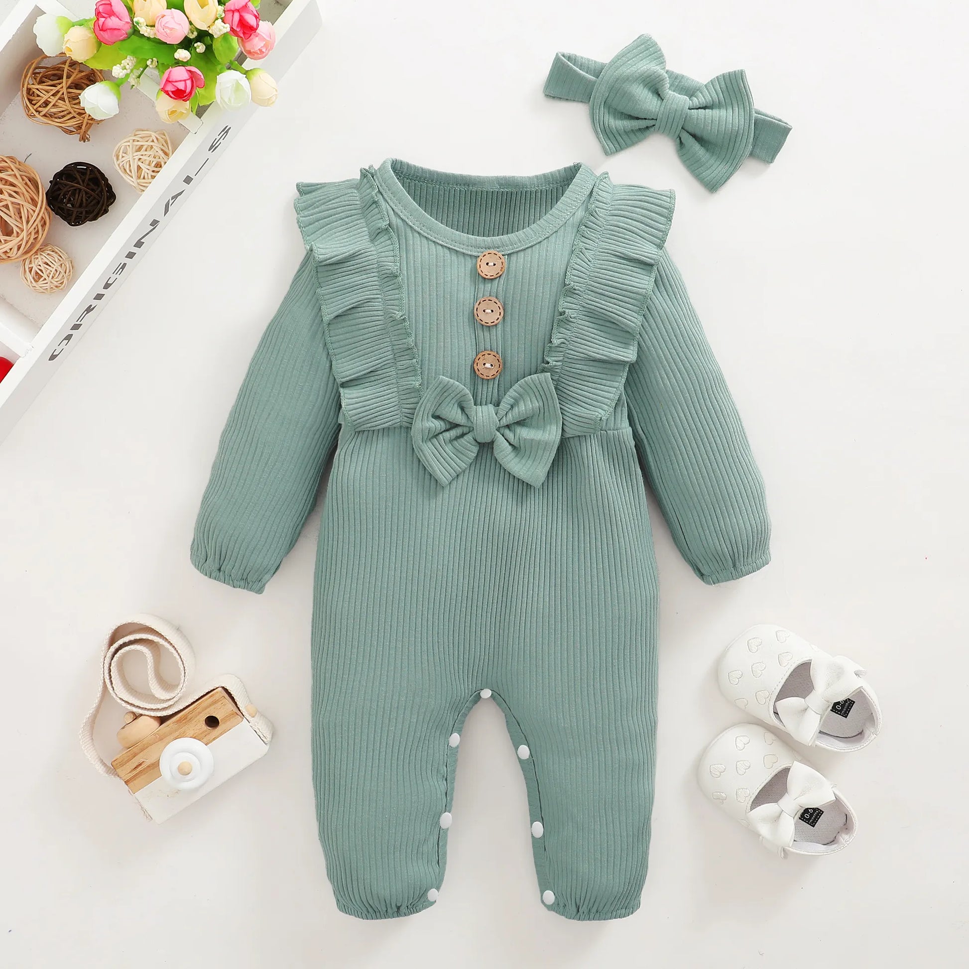 Adorable baby girl wearing a pink romper, one-piece infant clothing gift