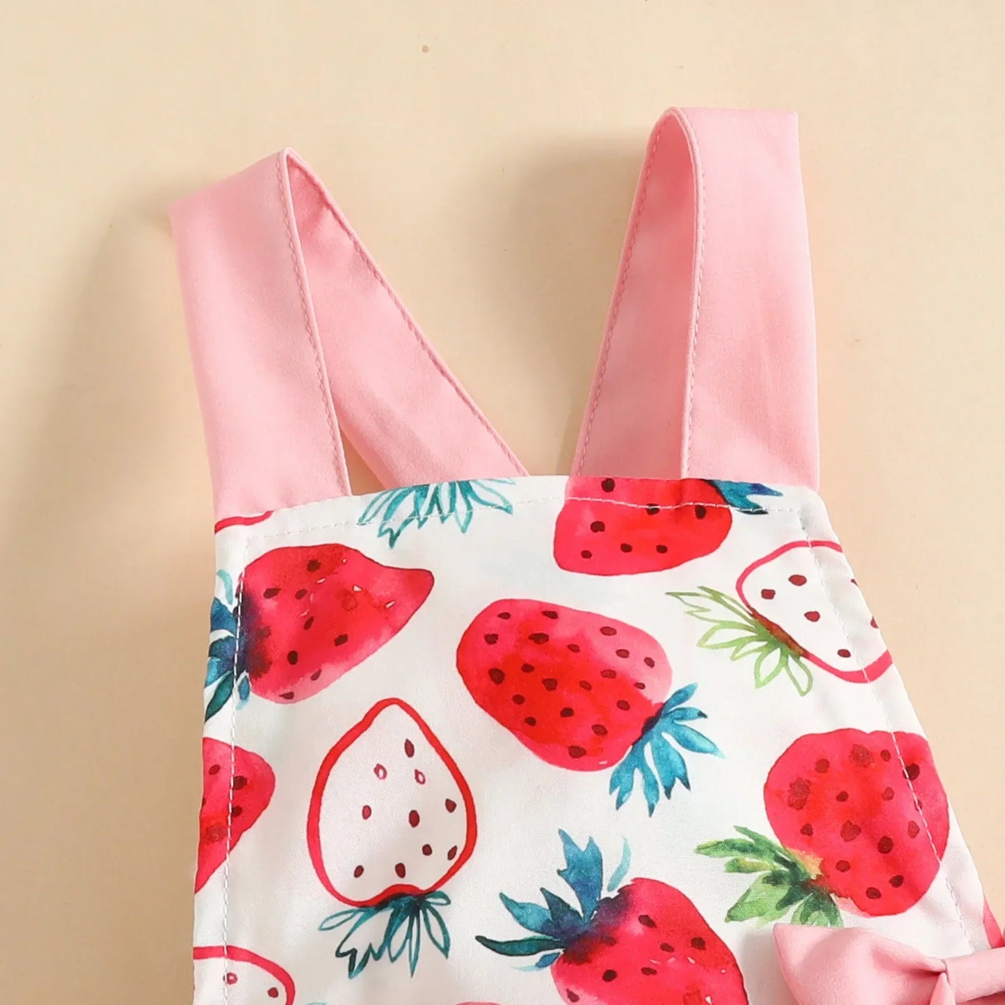 Baby girl's strawberry print romper set with an elastic headband, ideal for warm weather.
