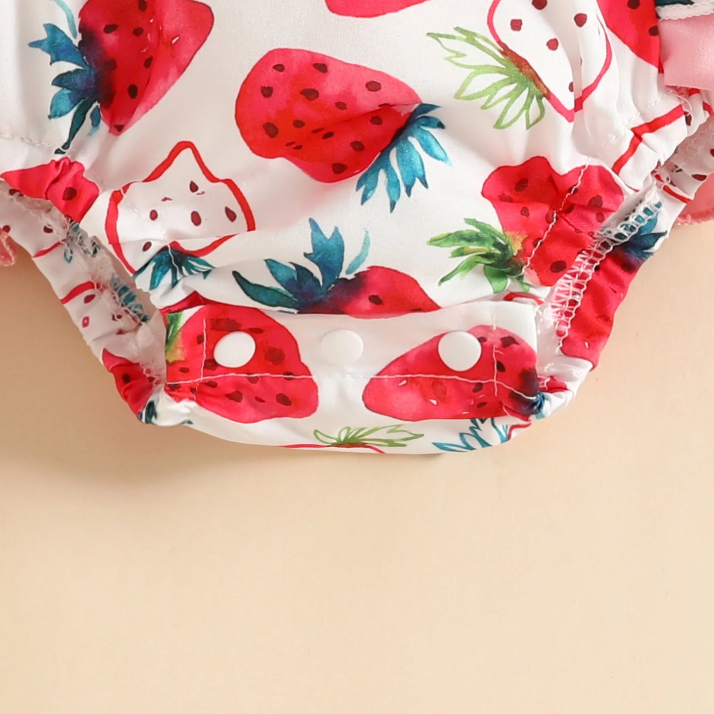 Charming infant girl's cow print bodysuit with a matching headband, a cute and trendy outfit.