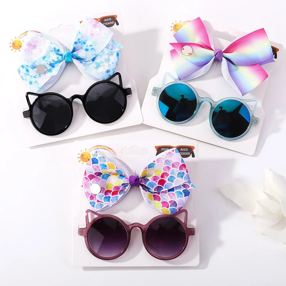 Baby girl's essentials: cute hair bows & playful cartoon sunglasses. Great for toddler fashion.
