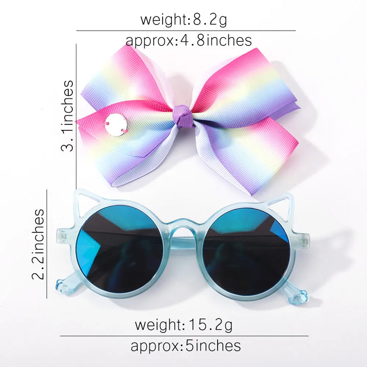 Adorable baby girl's accessory set: a cute bow and fun cartoon sunglasses. Gift idea.