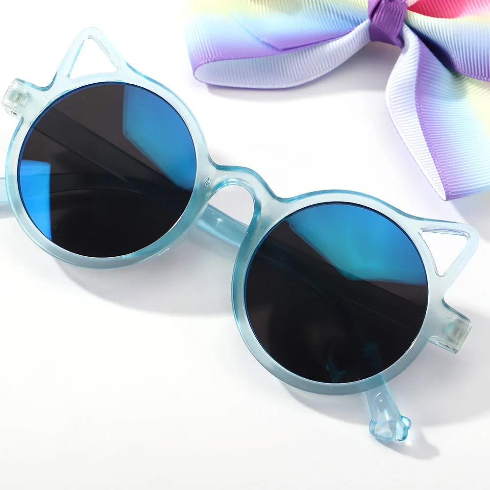 Infant girl's fashion statement: lovely hair bow and adorable cartoon sunglasses set.