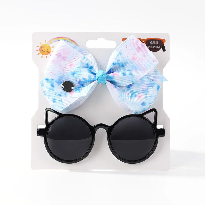 Stylish baby girl's eyewear & hair clip set, featuring cartoon sunglasses & a cute bow.