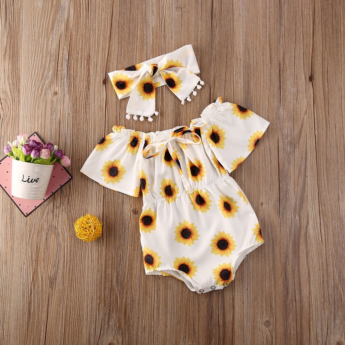 Cute baby girl's yellow sunflower cotton playsuit romper & matching headband, ideal for summer outfits.