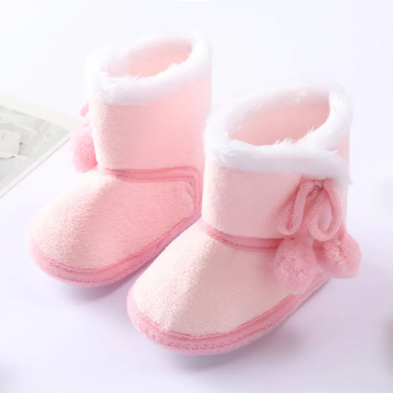 Baby girl fashion: pink winter high boots with a cozy plush cuff, perfect for chilly weather.