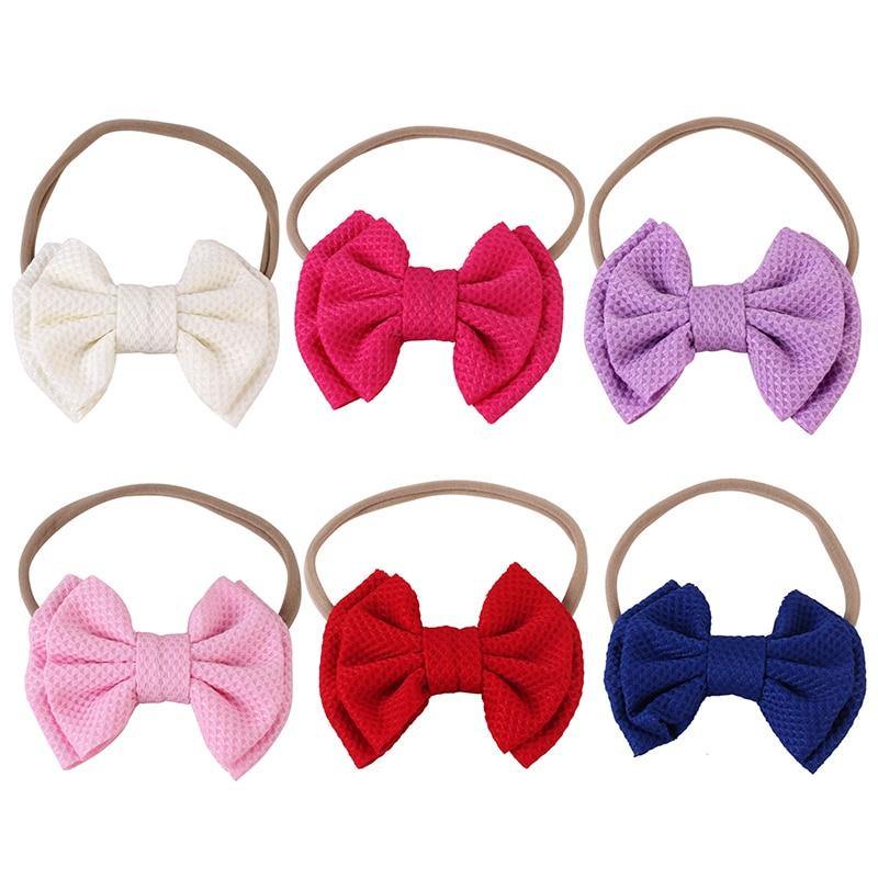 Adorable baby girls' pink elastic bow headband, perfect for infants and toddlers.