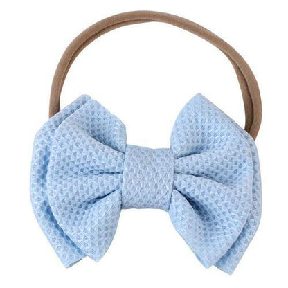 Soft fabric elastic bow headband for baby girls, gentle on delicate skin.