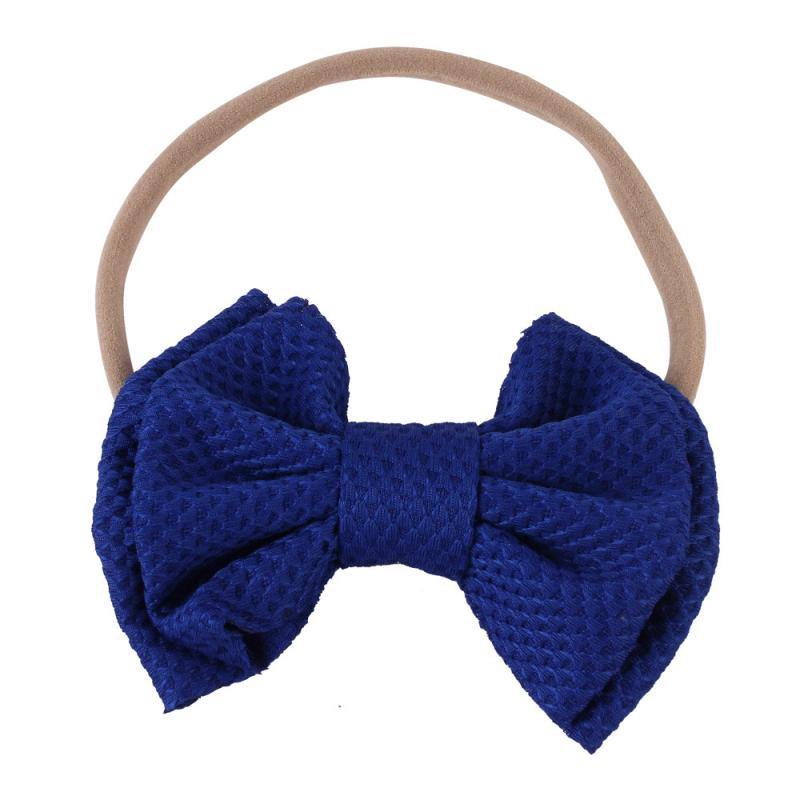 Soft white elastic bow headband, an elegant hair accessory for baby girls.