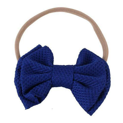Charming blue bow headband for infants, a soft and gentle hair accessory for babies.