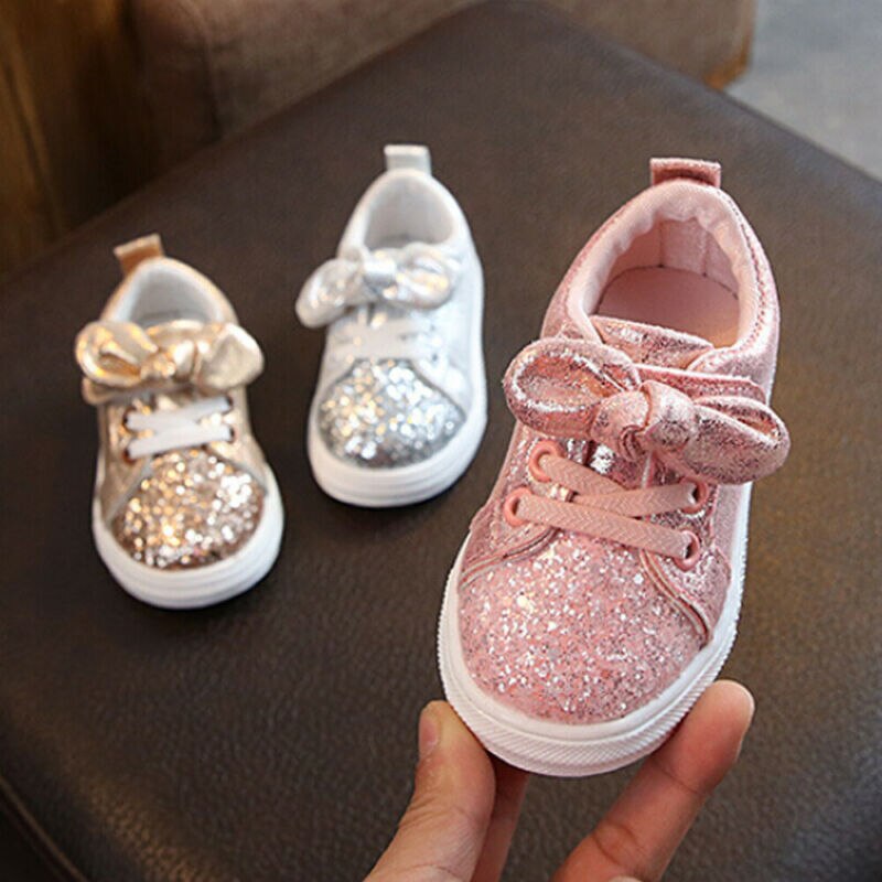 Adorable baby girls' pink glitter bowknot first walker sneakers with comfy sole.