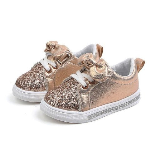 Side view of comfortable baby girls' first walker shoes featuring glitter and a cute bowknot.