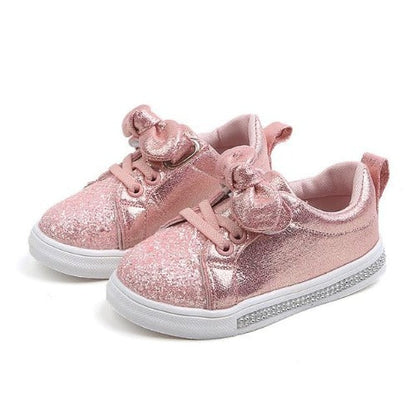Toddler girl's fashionable glitter bowknot sneakers in a soft pink, ideal for infants.