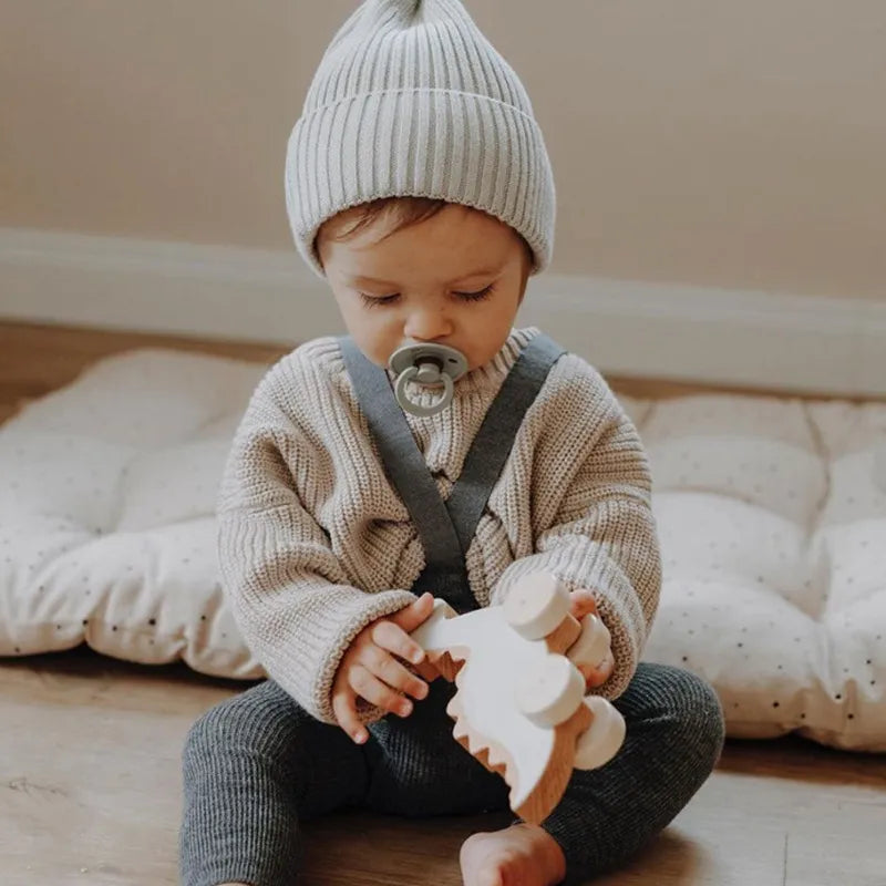 Stylish baby wearing a loose-fit knitted sweater, a must-have for autumn winter baby fashion.