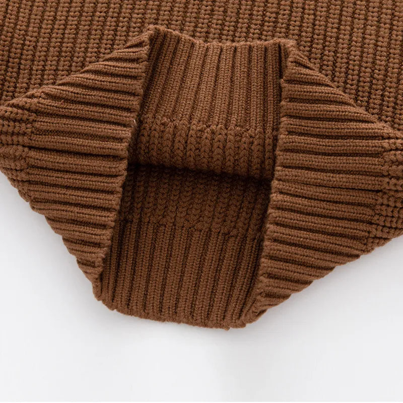 Baby in a relaxed knitted sweater, ensuring warmth and freedom of movement for autumn winter.