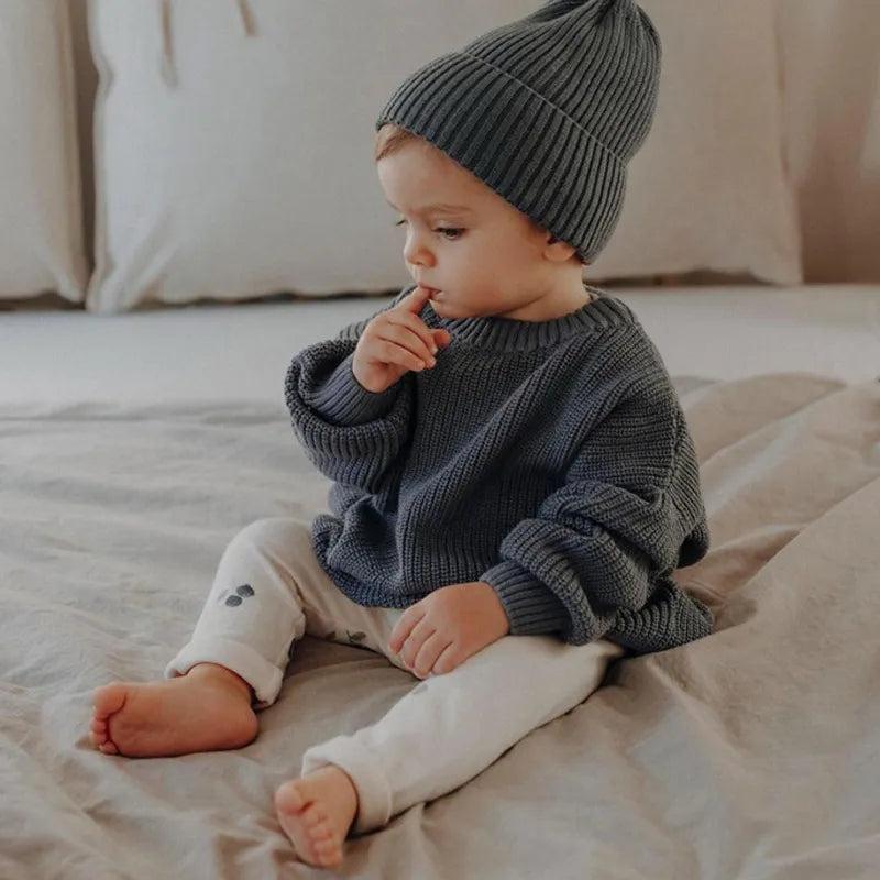 Charming toddler jumper, a warm knitted outerwear piece for babies, perfect for cold autumn winter days.