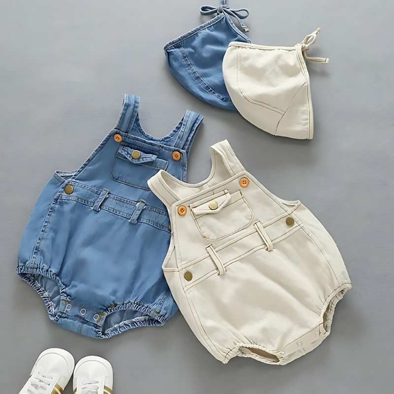 Adorable baby in a cozy white cotton romper and matching bonnet, perfect for infant comfort.