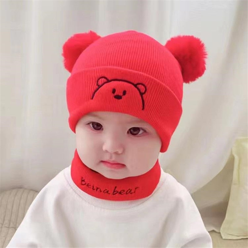 Closeup of a soft, chunky knit baby hat with a pom-pom, ideal for newborn winter outerwear.