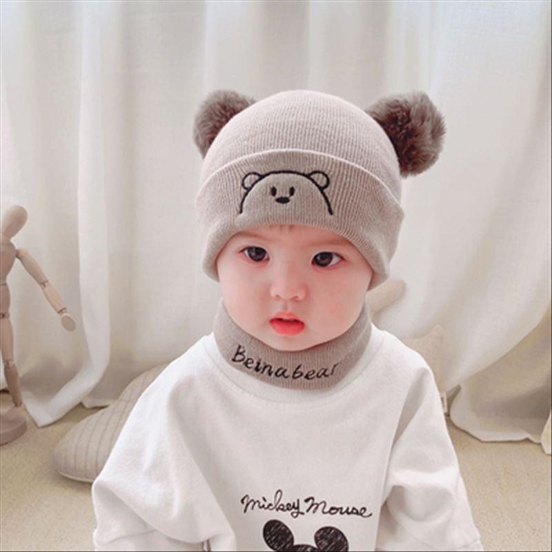 Charming baby winter set featuring a knit beanie and scarf in a neutral color, great for toddlers.