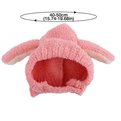 Side view of a baby girl wearing a pink rabbit ear plush hat, comfortable and stylish.