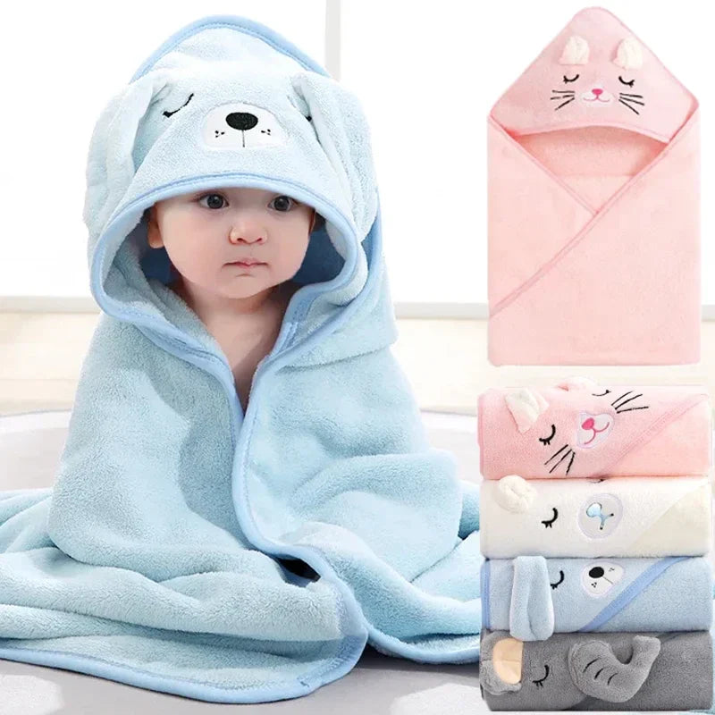 Adorable baby in a soft, absorbent coral fleece hooded bath towel with cute animal ears, perfect for newborns.