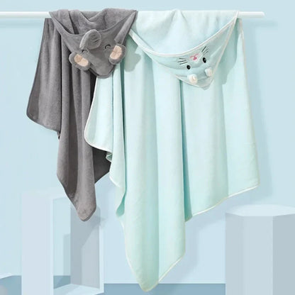 Close-up of a baby's happy face wrapped in a plush animal hooded bath towel, ideal for post-bath snuggles.