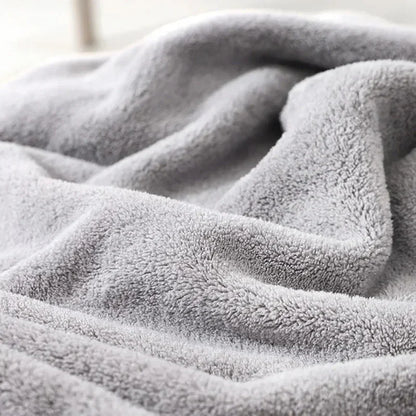 Baby wrapped in a cozy lion-themed hooded bath towel, highlighting the gentle material for delicate skin.