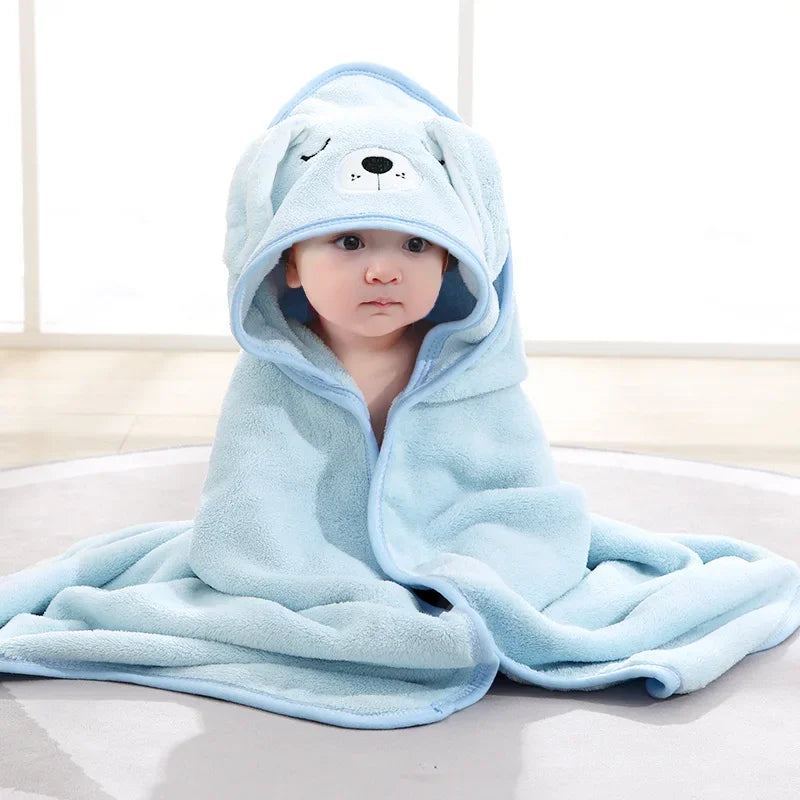 Toddler smiling while wearing a fun hooded elephant bath towel, demonstrating comfort and absorbency.