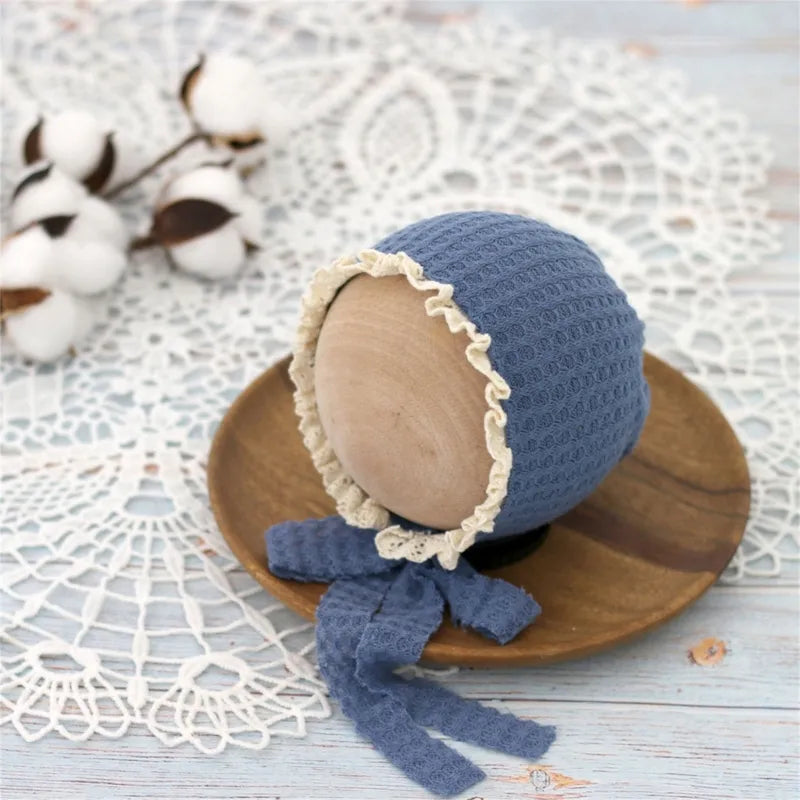 Happy baby wearing a fashionable, adjustable nylon beanie, showcasing headwear comfort.