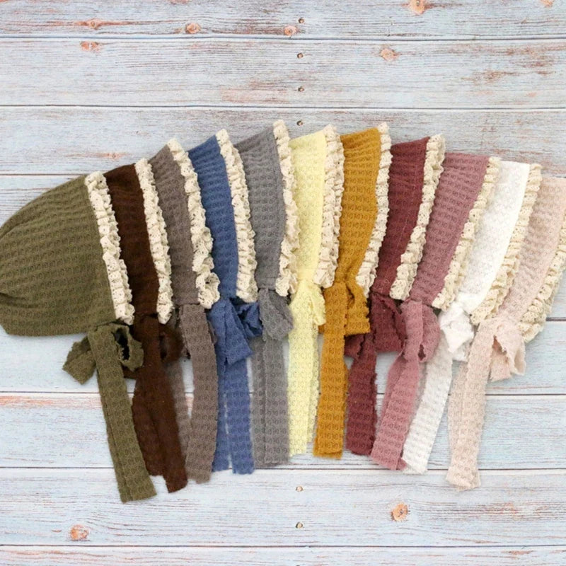 Closeup of a newborn wearing a cozy, adjustable nylon beanie, ideal for baby photography.