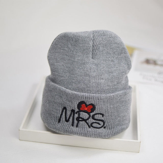 Smiling baby wearing a comfortable white knit toddler hat, soft cotton for delicate skin.
